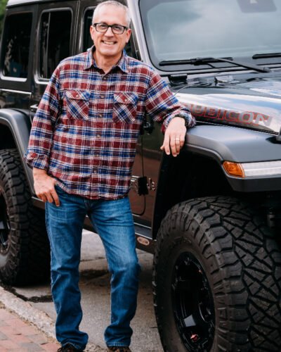 A photo of Luke Perisich beside his Jeep Wrangler